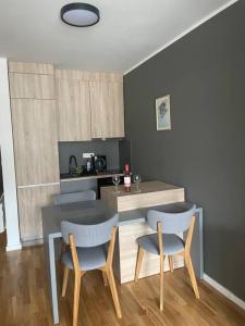 a kitchen with a table and two chairs and a table at Family Corner Bjelašnica in Bjelašnica +9 photos