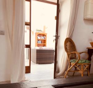 a room with a door open to a bedroom with a chair at Rincon Botanico at Tiagua81 Cosy Studio with shared pool in Tiagua