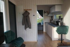 a small kitchen with a sink and a counter at Tinyhouse Heimatglück in Bad Berleburg