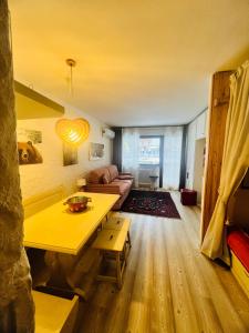 uma sala de estar com uma mesa amarela e um sofá em Casa degli orsi - Madonna di Campiglio - Condominio Nardis em Madonna di Campiglio