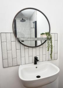 a bathroom with a sink and a mirror at The Cranny 2 Bed House in Central Morpeth in Morpeth