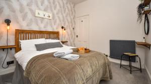 a bedroom with a bed with towels on it at The Cranny 2 Bed House in Central Morpeth in Morpeth