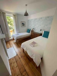a bedroom with two beds and a window at Warwick Weekender in Margate