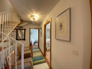 a hallway with stairs and a stair case at Agrovillaujue apartamentos rurales in Ujué +113 photos
