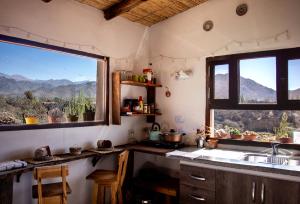 a kitchen with a sink and a large window at Cabaña Paraíso Cachi in Cachí +4 photos