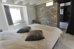 a bedroom with a large bed with two pillows on it at Borgo Stanzano in Zocca