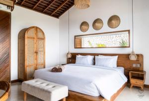 a bedroom with a large white bed and a window at Sundance Residence Nusa Penida - 2 Bedroom with Private Pool Villa in Tanglad +25 photos