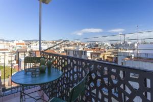 a balcony with a table and a view of a city at Feel Welcome Barcelona # SPLAU in Cornellà de Llobregat