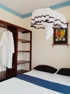 - une chambre avec un lit et un lustre dans l'établissement Marieella homes, à Ukunda