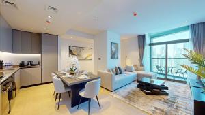 a living room with a blue couch and a table at Primestay - 15 Northside 2BR in Business Bay in Dubai