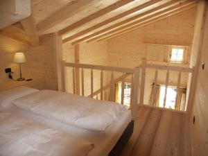 a bedroom with a bed in a wooden cabin at Chalet da mont Resciesa in Ortisei
