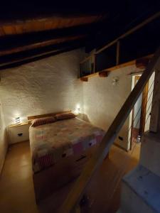 a attic room with a bed and a staircase at Relais du Bourg in Roisan
