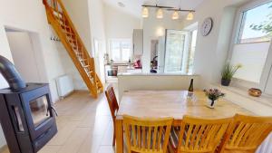 a kitchen and dining room with a table and a stove at Feriendorf Südstrand Haus 21 in Pelzerhaken