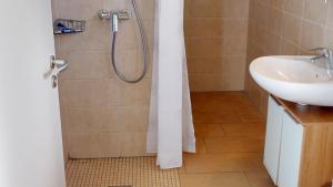 a bathroom with a shower and a sink at Feriendorf Südstrand Haus 21 in Pelzerhaken