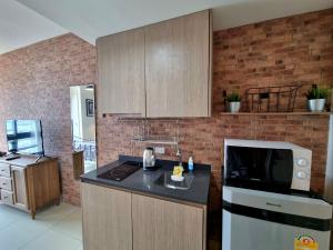 a kitchen with a counter top and a microwave at unixx condo pattaya near walking street in Pattaya South