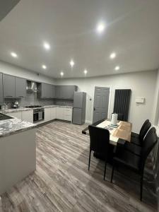 a large kitchen with a table and chairs in it at 4 Bedroom Detached House in Liverpool