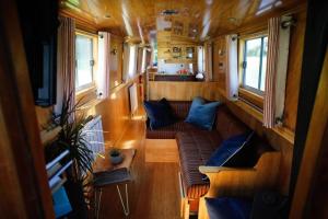 a view of a living room in a train car at Beautiful New Moon Narrowboat in Cambridge