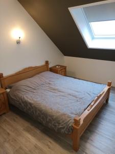 a bedroom with a bed and a skylight at de Paardekracht in Serooskerke