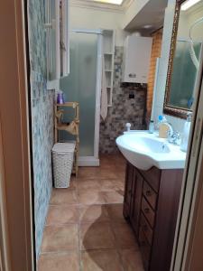 a bathroom with a sink and a mirror at La Grotta del Leone in Potenza