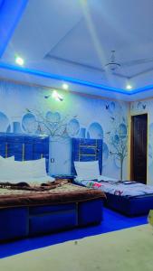 a room with two beds and a mural on the wall at KHYBER INN in Islamabad