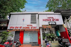 a house with two motorcycles parked outside of it at OYO Hotel Homestay Near Chhatrapati Shivaji International Airport in Mumbai