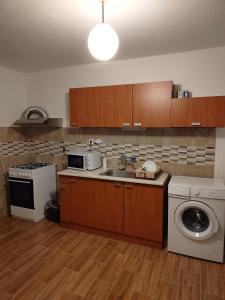 a kitchen with a sink and a washing machine at Mária in Košice