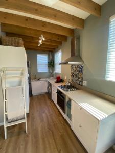 a kitchen with white counters and wooden ceilings at The Vine in Bellville