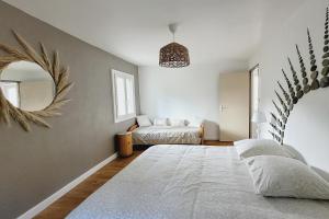 a bedroom with a bed and a mirror at Maison Pierres Bois Feuilles in Alzon