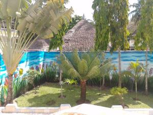 a mural of a resort with palm trees at Blessing holiday homes - Diani Beach in Diani Beach
