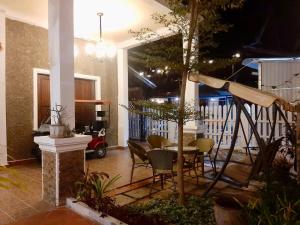 a patio with a table and chairs in a house at Ban Channuane in Luang Prabang