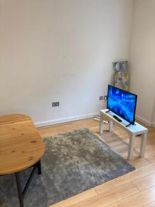 sala de estar con mesa y ordenador portátil. en Two double bedroom flat in Soho, en Londres