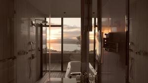 a bathroom with a shower and a sink and a mirror at Gezi Hotel Bosphorus, Istanbul, a Member of Design Hotels in Istanbul