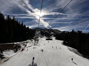 a group of people skiing down a ski slope at La Maison aux Volets Bleus 3ème Étage in Vic-sur-Cère +21 photos