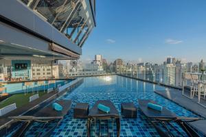 a swimming pool on the top of a building at Montraj Continent Sukhumvit Bangkok in Bangkok