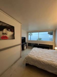 a bedroom with a bed and a large window at Château de la mer, by Welcome to Cannes in Cannes