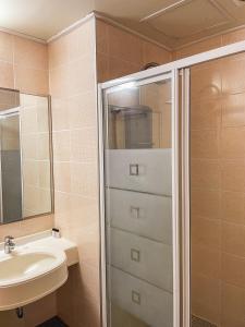 a bathroom with a sink and a shower at Hotel Terramar in Boryeong