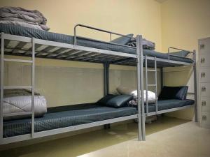 a room with two bunk beds in a room at Happy Living Hostel in Dubai