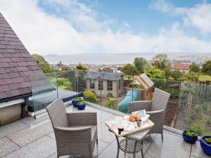 a patio with a table and chairs on a balcony at 1 bed property in Paignton 82557 in Paignton