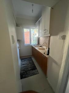 a small kitchen with a sink and a window at DERVİŞ BEY KONAĞI in Istanbul