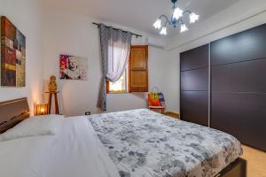 Un dormitorio con una gran cama blanca y una ventana en Case Vacanze Castellana Iris, en Sciacca