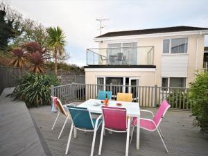 a table and chairs on a deck in front of a house at 3 Bed in Torquay 82959 in Torquay