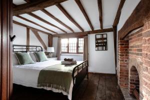 a bedroom with a bed with a teddy bear on it at The Bank House in Ditchling