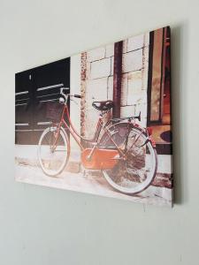 a painting of a bike parked next to a building at SERENE ACCOMMODATION PALACE in Bela-Bela