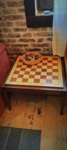a chess board with a pizza on top of it at Uki & Sofi mountain house in Kopaonik