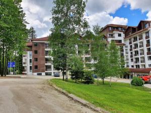 an empty street in front of a large building at Borovets Gardens Funky Fresh Studio by Joro in Borovets