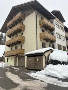 a large apartment building with snow in front of it at Sonnenblick in Bad Tölz