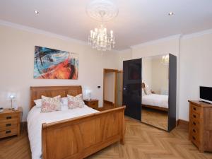 a bedroom with a bed and a chandelier at 1 Bed in Llandudno 83621 in Llandudno