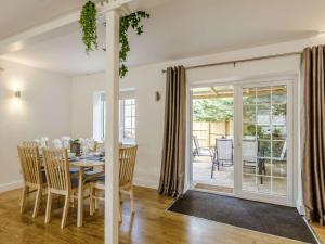 a dining room with a table and chairs and a patio at 3 bed in Wedmore 83630 in Edington
