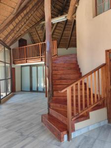 an empty room with wooden stairs in a building at GEORGE B BOUTIQUE LODGE in Tzaneen