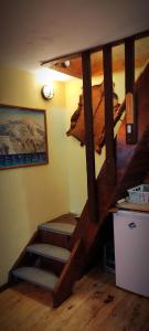 a room with a staircase in a room with a wall at Uki & Sofi mountain house in Kopaonik